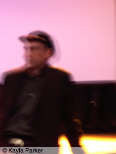 Kayla's photo of Jem Cohen sitting on the stage at Aurora in Norwich, talking about film