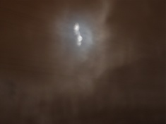 a few seconds later, photo of full moon taken through branches of the birch tree in the back garden