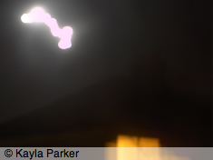 photo of full moon rising over JL's roof, hand-held from boiler room window