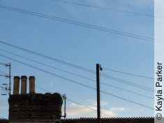 Kayla's photo of the young crescent moon just above the chimney, a minute later