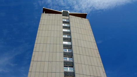 still from the film Cinematic City showing the north face of the Civic Centre, looking up from ground level to a deep blue sky with some skeins of high white cloud