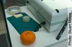 Photo of left hand side of lightbox: masking tape, A5 cutting mat, satsuma etc